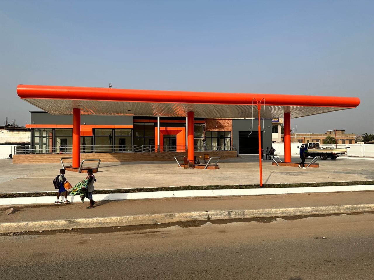 A completed Flogal-built fuel station with a sweeping orange canopy in Ghana