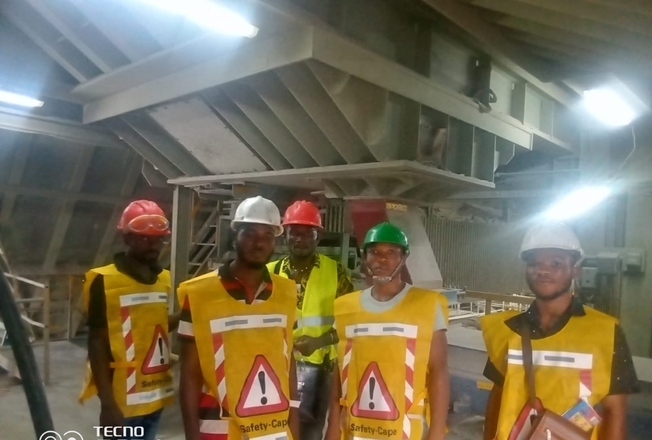 Flogal site crew in hard hats and hi-vis at an industrial plant in Ghana